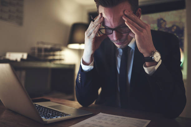 istock Pensive office worker accounting in the evening 699826782