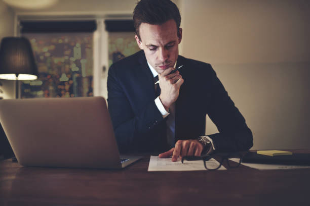 istock Pensive office worker accounting in the evening 699827616