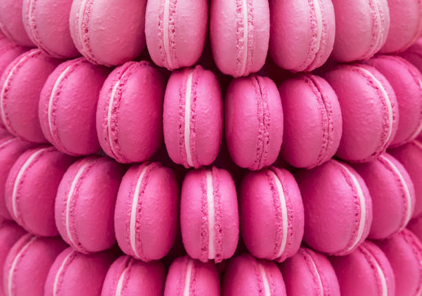 istock lot a ,pink macarons in a row background 699828228
