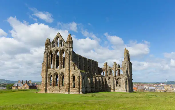 Whitby Abbey North Yorkshire uk ruins in summer on hillside over tourist town and holiday destination