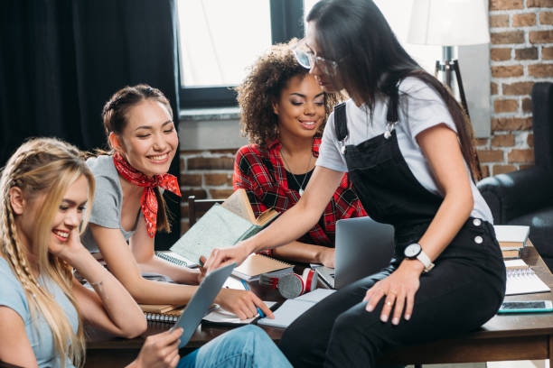 istock smiling multiethnic women working while sitting at table in home office 699832800