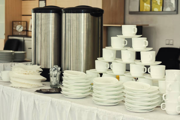 istock tea sets, collection white coffee cups, buffet, catering,Plates stacked on a table,Preparation for serving table 699834242