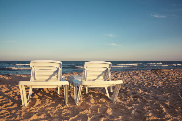 istock Two deckchairs on the sandy beaches for tourists 699836528
