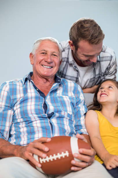 istock Happy family sitting on sofa 699848316