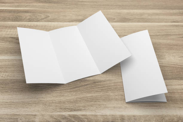 istock Blank 3D rendering tri-fold brochure mock-up with clipping path on wood No. 1 699848398