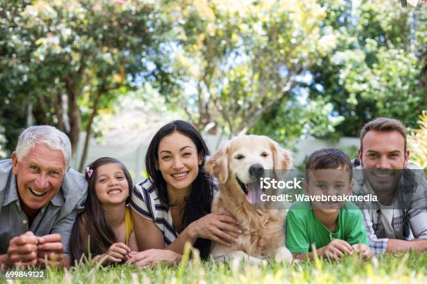 Happy Family In A Park Stock Photo - Download Image Now - Dog, Pets, Multi-Generation Family