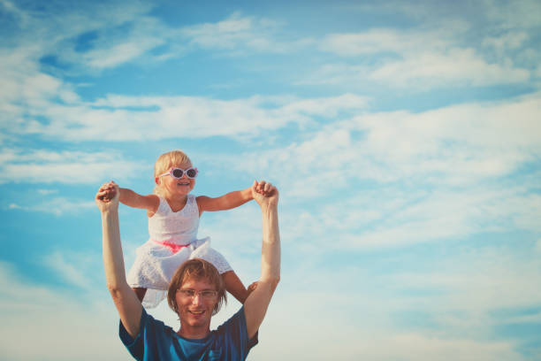 istock Father and little daughter play at sky 699855860