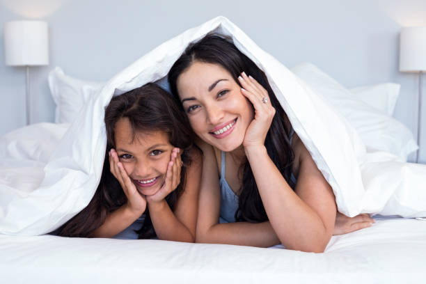 istock Woman relaxing with her daughter 699855878