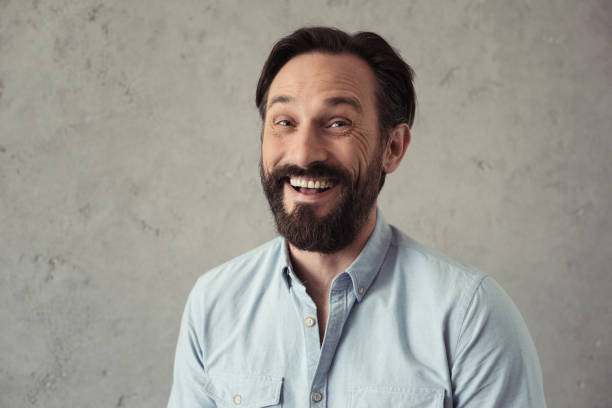 istock portrait of handsome bearded man smiling and looking at camera 699867166