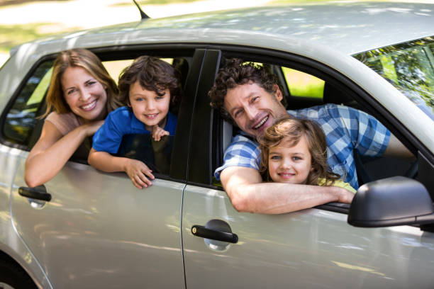 istock Smiling family sitting in a car 699867546