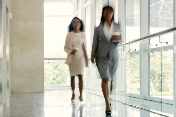 istock Businesswomen Walking down Office Corridor 699867622