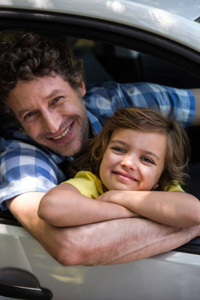 istock Father and daughter sitting in a car 699867648