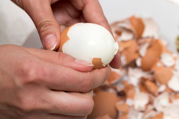 istock The girl is cleaning the egg with her hands 699871574