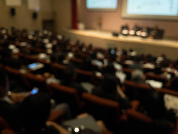 istock Abstract blurred businessman lecture in seminar room 699877750
