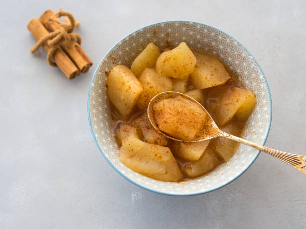 Baked apple with cinnamon Baked apple with cinnamon. No sugar fruit diet dessert compote stock pictures, royalty-free photos & images