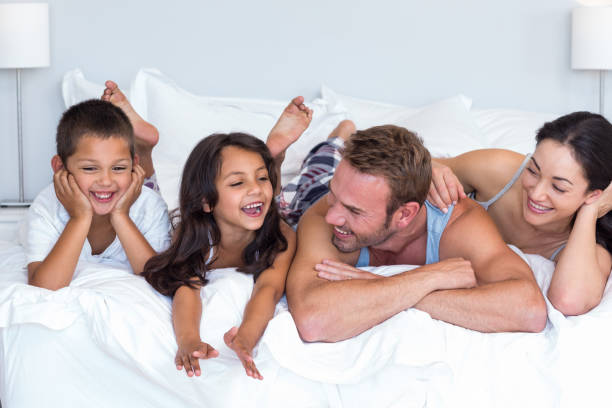istock Happy family in their bedroom 699883236