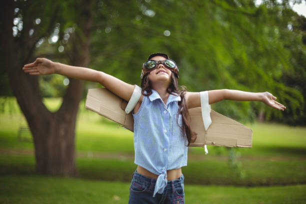istock Young girl pretending to fly 699883300