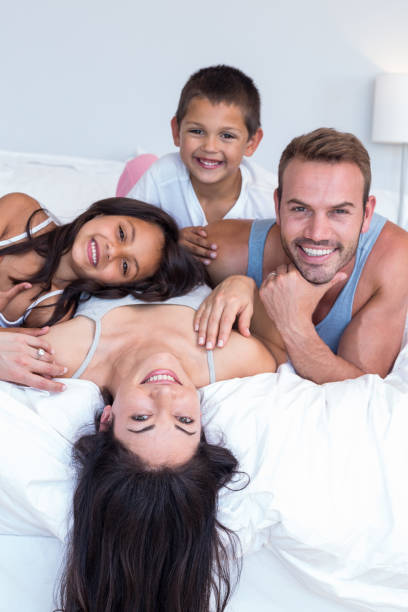 istock Happy family in their bedroom 699883676