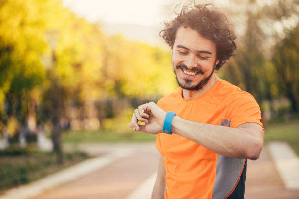 istock Sportsman looking at his smart watch 699885336