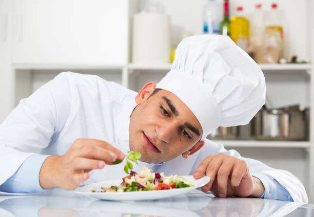 istock Professional cook is degustating salad 699889024