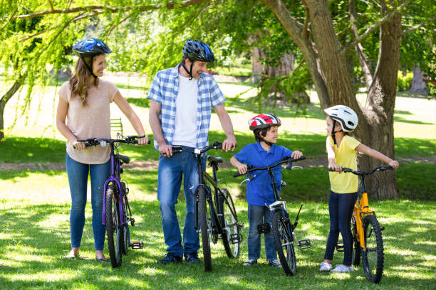 istock Smiling family with their bikes 699890074
