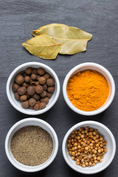 istock Fresh colorful spices in white bowls on black slate plate. 699931152