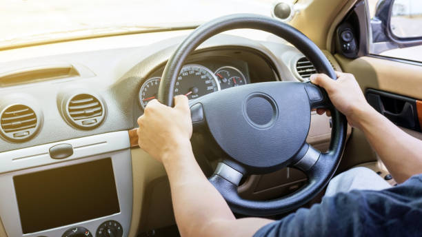 istock Asian young man driving a car. 699935692