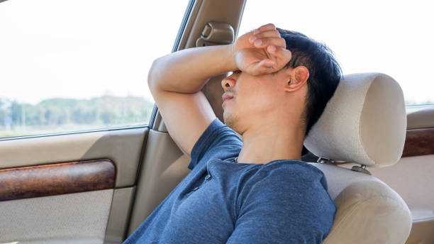 istock Asian young man sleeping in his car. 699938244
