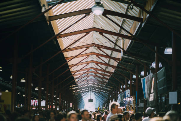 Busy Day At Queen Victoria Market High angle shot of the Queen Victoria Market in Australia. It is a busy summer day. melbourne street crowd stock pictures, royalty-free photos & images