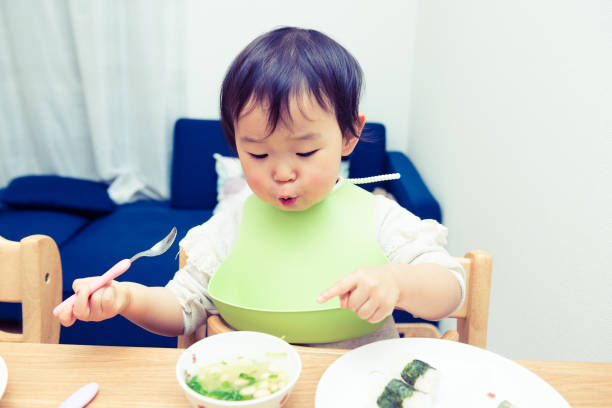 istock Cute baby with a meal 699974150