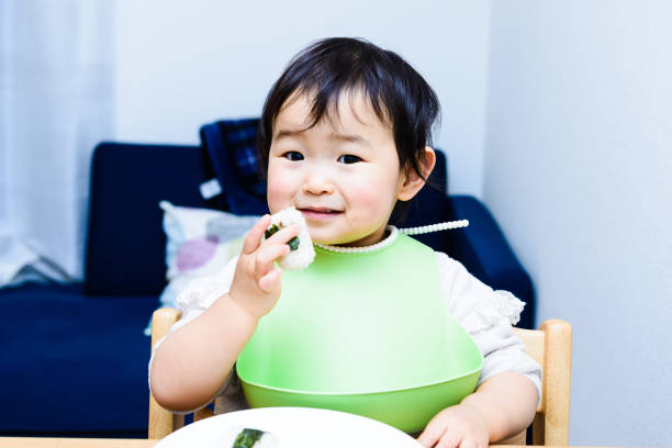 istock Cute baby with a meal 699974684