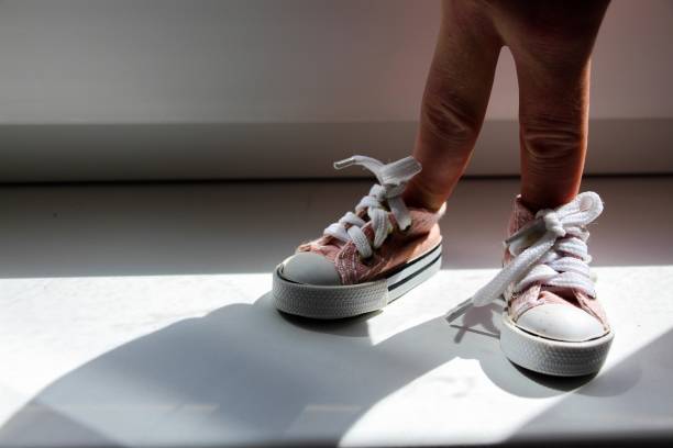 istock Setting - fingers are dressed in sneakers. Standing position. 699975236