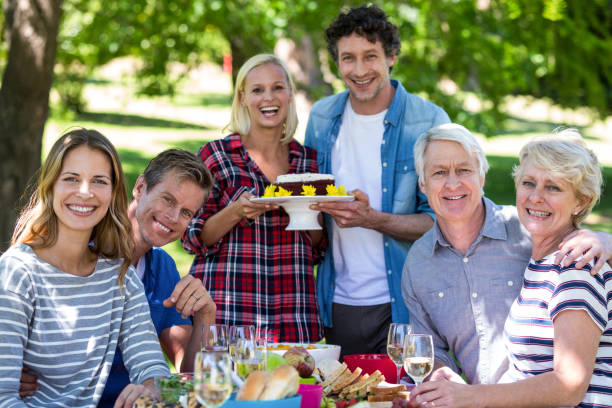 istock Friends having a picnic with cake 699975762