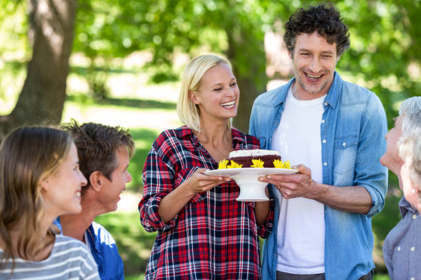 istock Friends having a picnic with cake 699975836