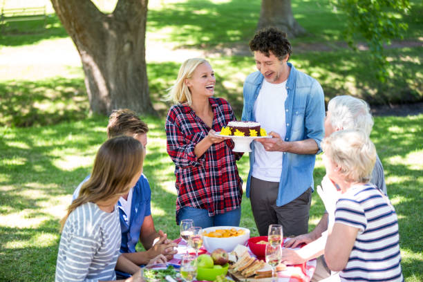 istock Friends having a picnic with cake 699975936