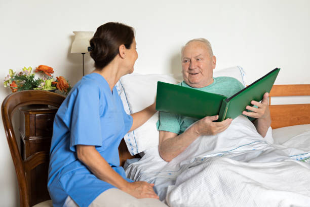 istock Female caregiver and senior man 699998680