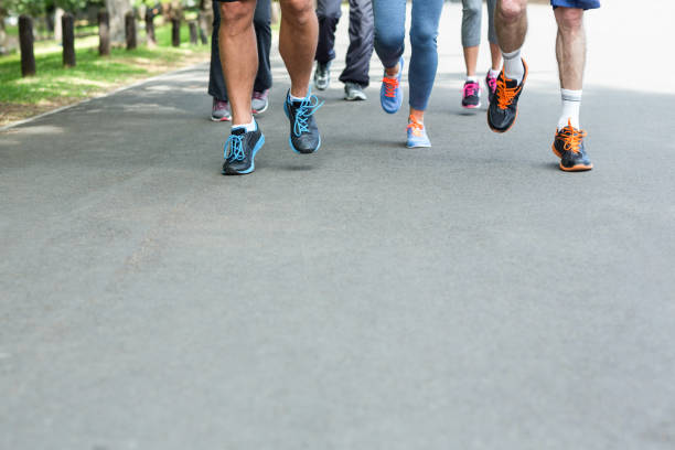 istock Cropped view of marathon athletes feet running 700072684