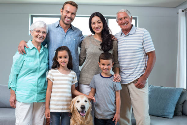 istock Family standing together with dog 700072766