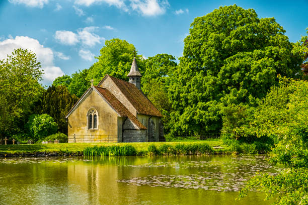 St Leonards Church Hartley Mauditt Hampshire England Twelfth century church in Hartley Mauditt in Hampshire, England norman uk tree sunlight stock pictures, royalty-free photos & images