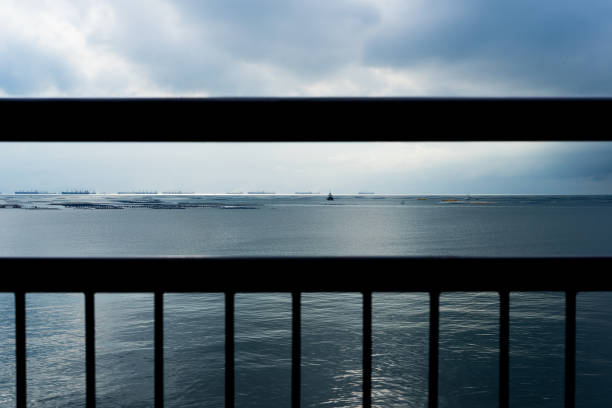 istock Terrace view of cargo ships and fish farm under rain 700077236