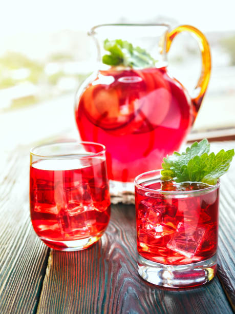 istock Berry compote decanter glasses with apple slices on wooden rustic background solar. 700077474