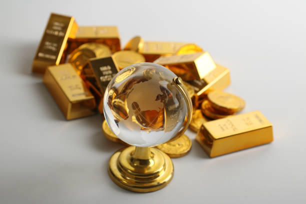 Coins and ingots with glass globe Coins and ingots with glass globe ingot photos stock pictures, royalty-free photos & images
