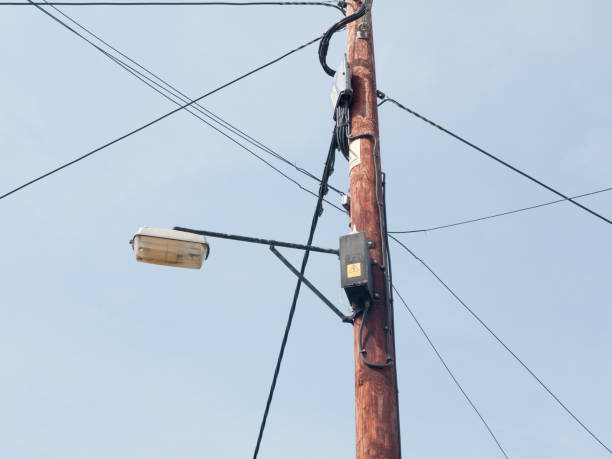 istock wooden post with wires and boxes 700085412