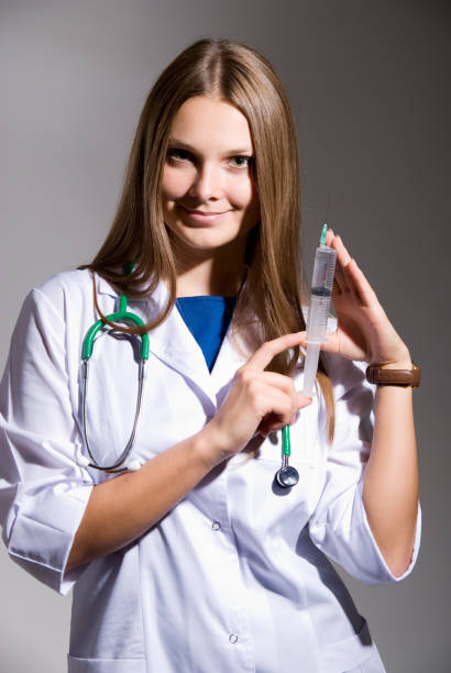 istock Doctor holding a syringe in his hand 700088352