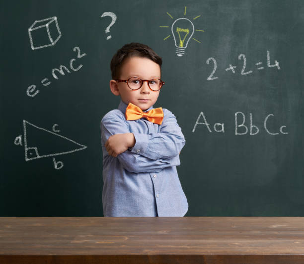 istock Cute child is in front of chalkboard 700097770