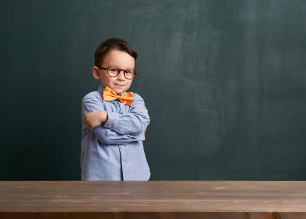 istock Cute child is in front of chalkboard 700097772