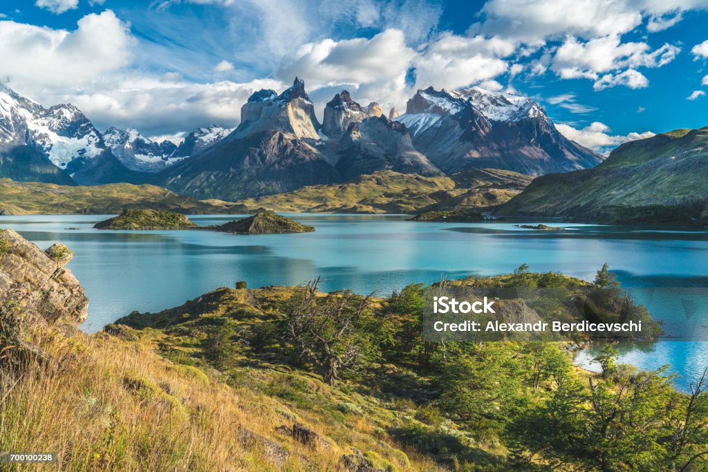Blue lake on a snowy mountains background and cloudy sky Torres del paine Torres del Paine National Park Stock Photo