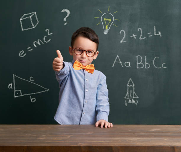 istock Cute child is in front of chalkboard 700100296