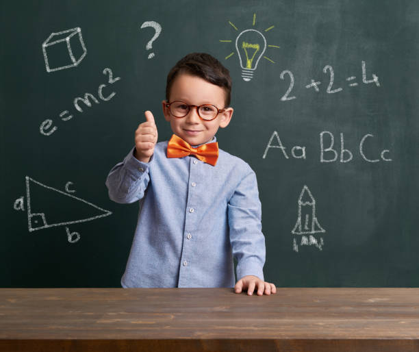 istock Cute child is in front of chalkboard 700100704