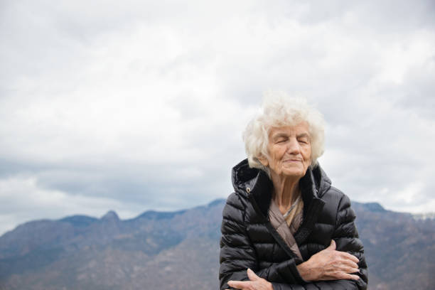 istock Senior Woman Outdoors Lost in Thoughts 700100892